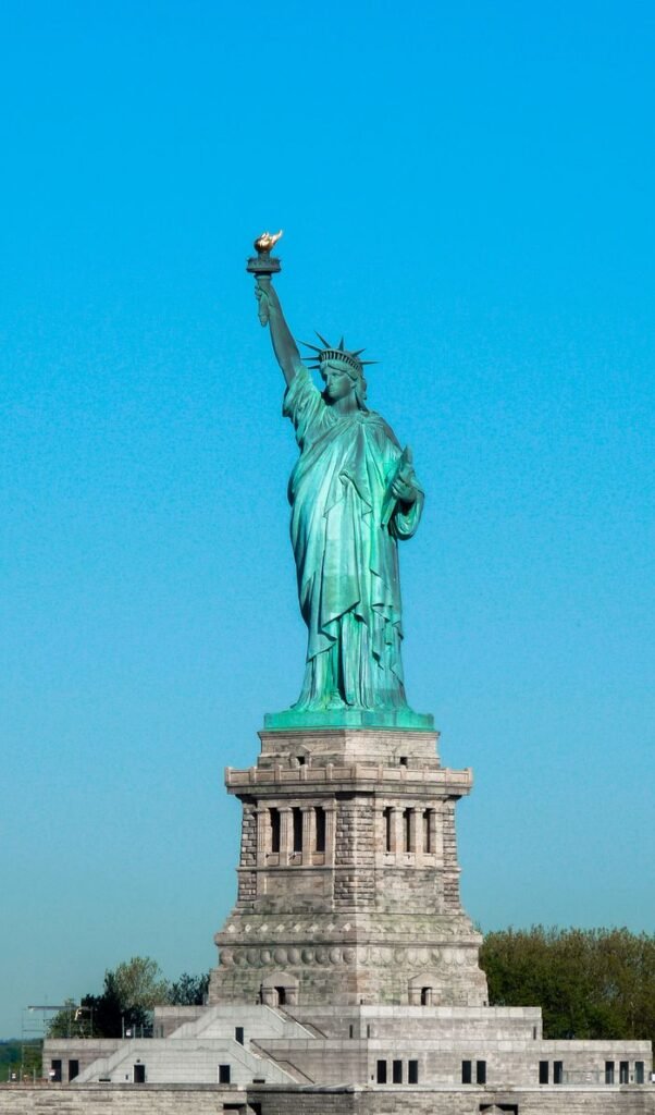 A stunning shot of the Statue of Liberty against a clear blue sky in New York City.